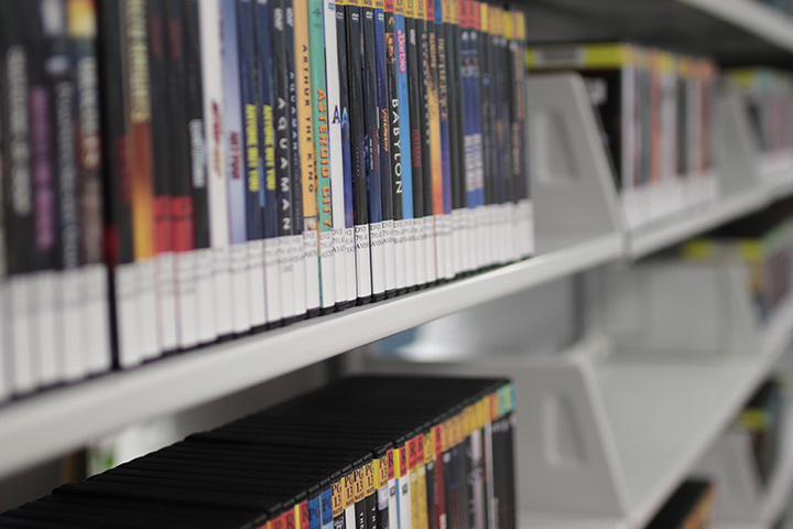 Several rows of DVDs on shelf